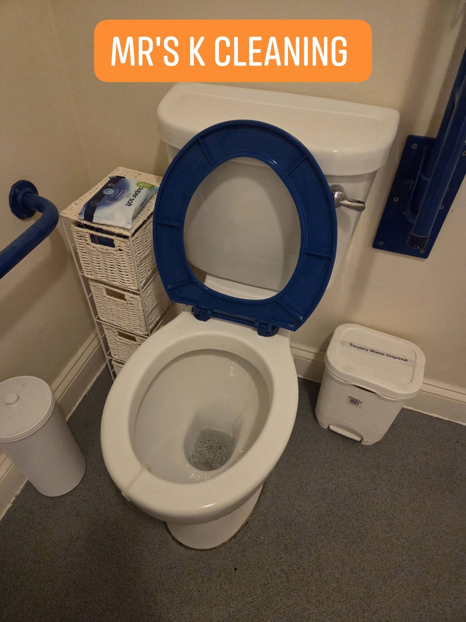 Bathroom toilet with blue seat open lid