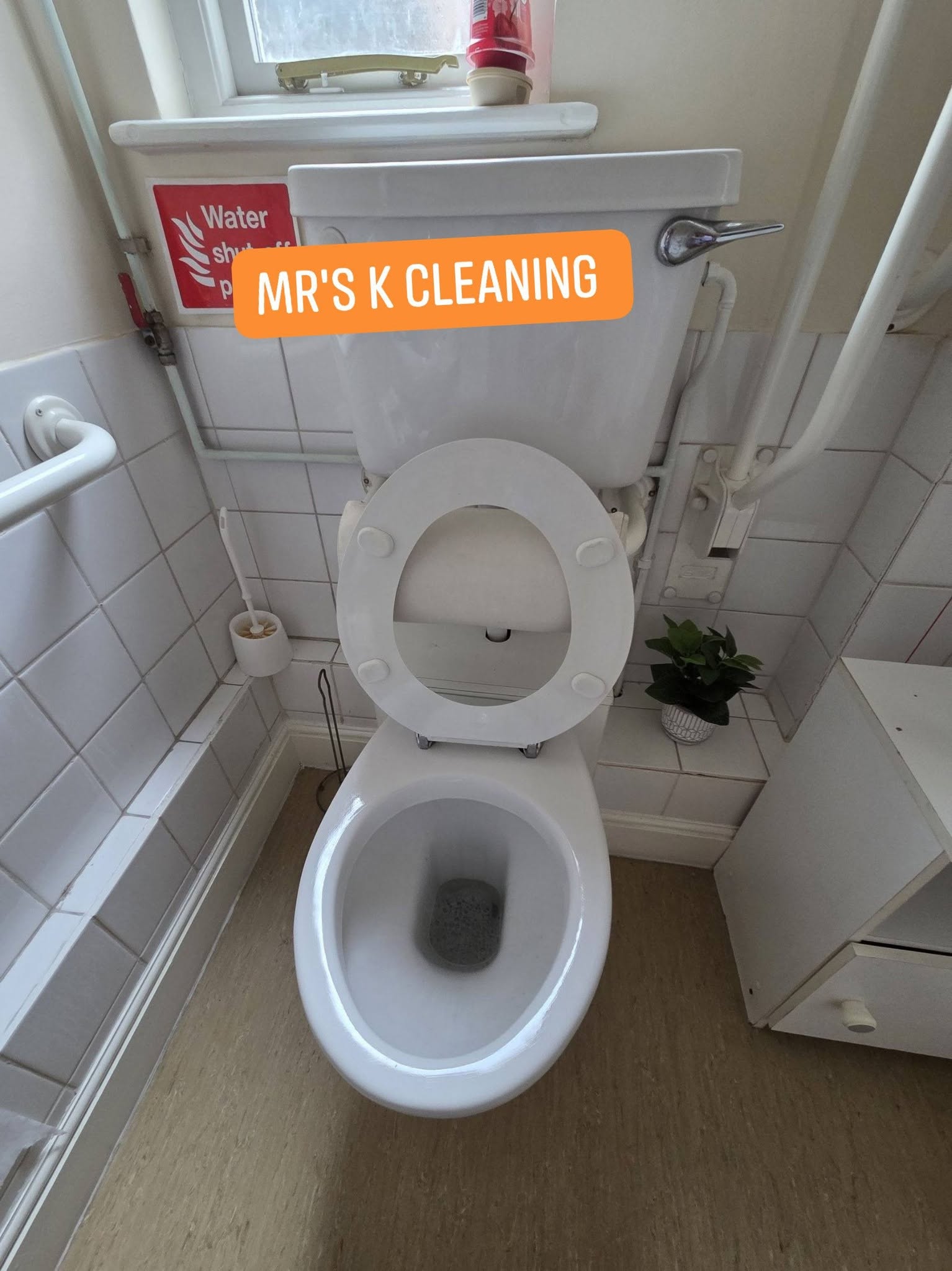 Clean white toilet with raised seat