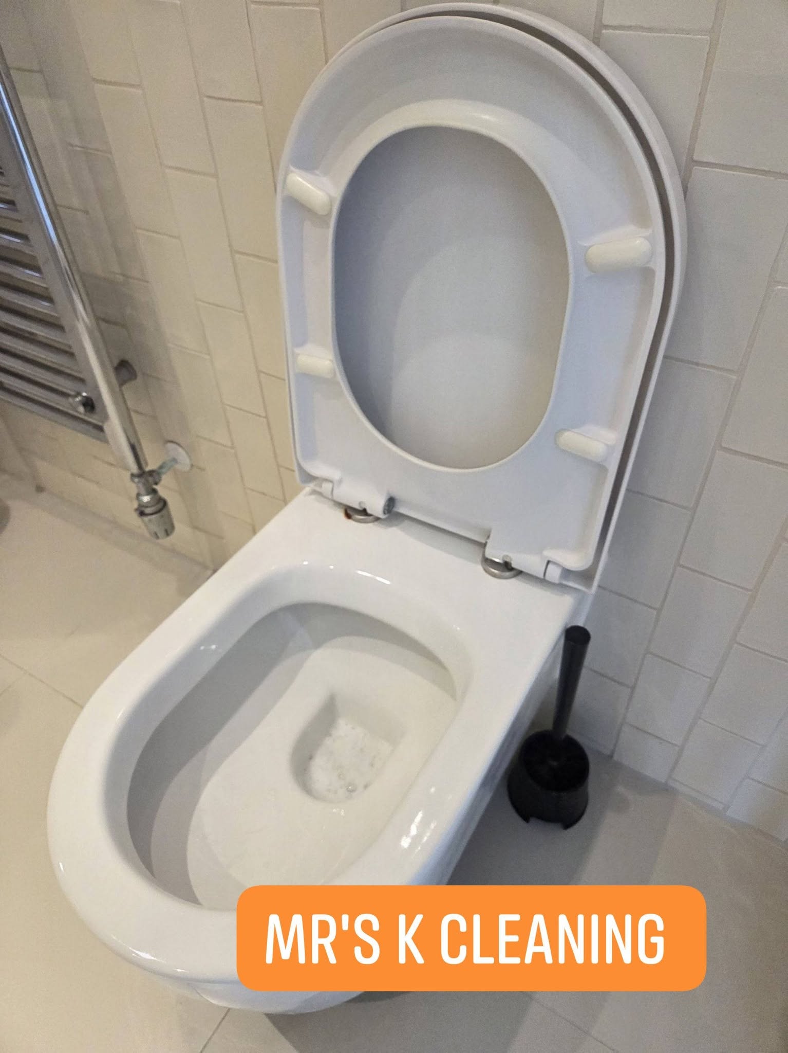 Clean white toilet with open lid